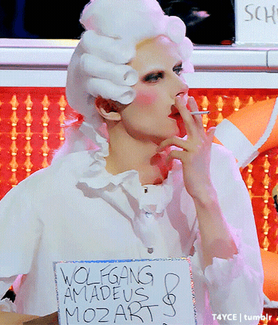 Woman In White Wig Smoking Holding Wolfgang Amadeus Mozart Sign GIF