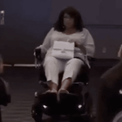 Woman In Wig And Earrings Making Funny Face GIF