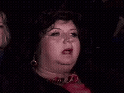 Woman In Wig And Earrings Making Funny Face GIF