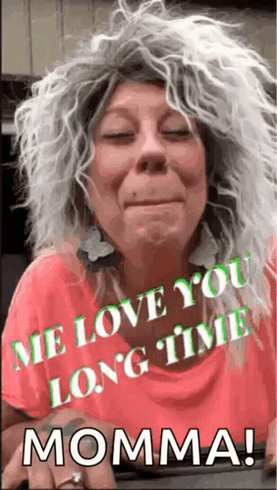 Woman In Wig And Earrings Says Me Love You Long Time Momma GIF