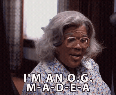 Woman In Wig And Glasses Saying I'm An O.G. M-A-D-E-A GIF