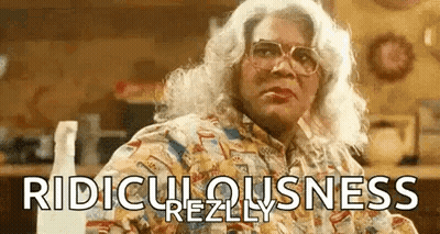 Woman In Wig And Glasses With Spray Bottle GIF