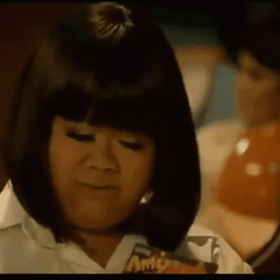 Woman In Wig Eating Candy Bar GIF
