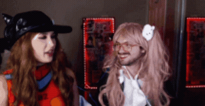 Woman In Wig Next To Man GIF