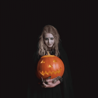 Woman In Witch Costume Holding Pumpkin Saying I Wish You A Happy Halloween GIF