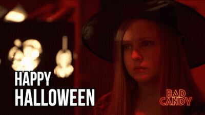 Woman In Witch Costume Saying Happy Halloween GIF