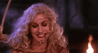 Woman in Witch Costume Smiling Hanging on Rope