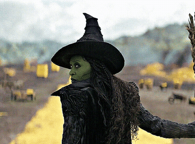 Woman In Witch Costume Standing In Field GIF