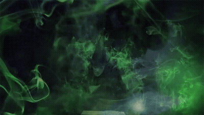 Woman In Witch Costume With Green Smoke From Book GIF