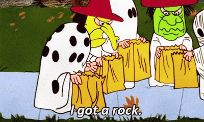 Woman In Witch Hat Next To Pumpkin GIF