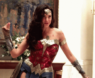 Woman In Wonder Woman Costume In Front Of Painting GIF
