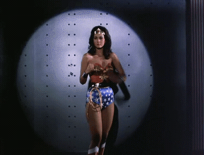 Woman In Wonder Woman Costume In Front Of Spotlight GIF