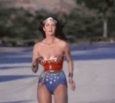 Woman In Wonder Woman Costume Running Across Road GIF