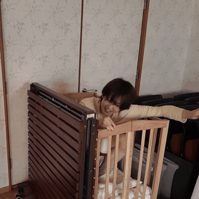 Woman In Wooden Crib Arms Outstretched 'A GIF