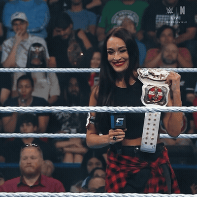Woman In Wrestling Ring Holding Belt With B GIF