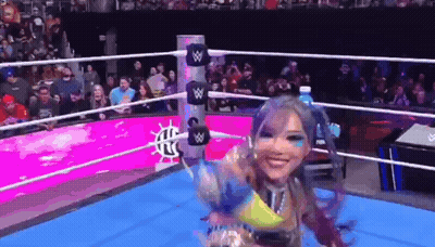 Woman In Wrestling Ring Holding Water Bottle GIF