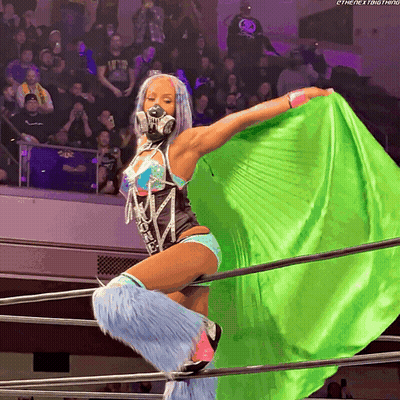 Woman In Wrestling Ring With Green Cape And Mask GIF