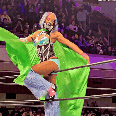 Woman In Wrestling Ring With Green Cape Saying The Next Thing GIF