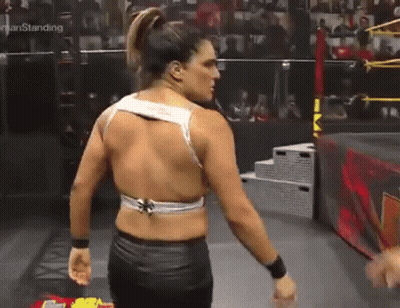 Woman In Wrestling Ring With Man Behind Her GIF