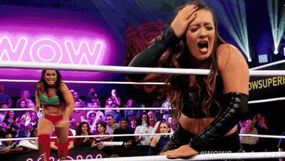 Woman In Wrestling Ring With Neon Sign Saying Now GIF