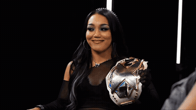 Woman In Wrestling Ring With NXT Sign GIF