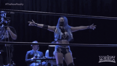 Woman In Wrestling Ring With Prestige Logo GIF