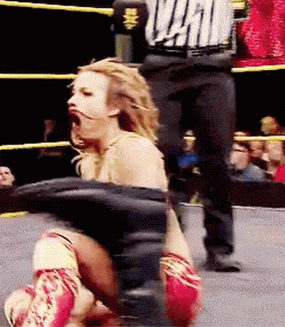 Woman In Wrestling Ring With Referee Wearing WWE Shirt GIF