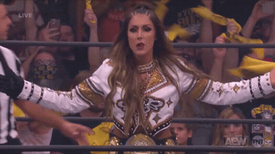 Woman In Wrestling Ring With TNT Logo GIF