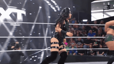 Woman In Wrestling Ring With XT On Screen GIF