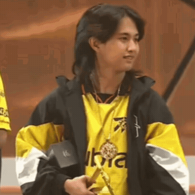 Woman In Yellow And Black Jacket Holding Medal GIF