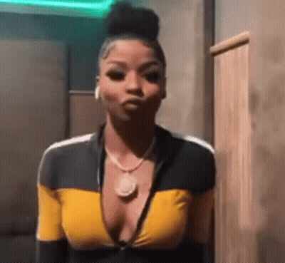 Woman In Yellow And Black Top Making Face GIF