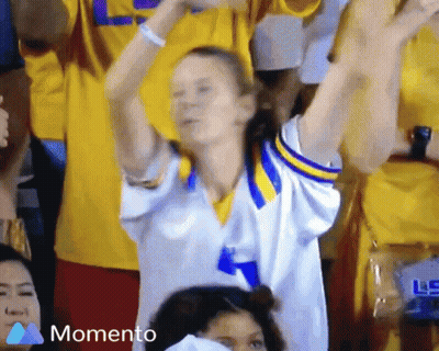 Woman In Yellow And Blue Jersey Cheering GIF