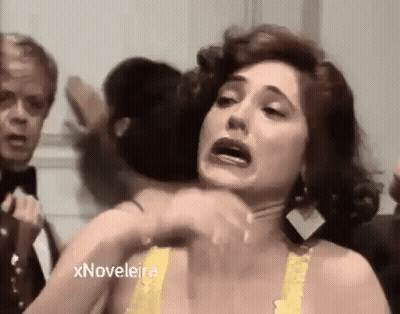 Woman In Yellow Bra Making Funny Face With Man In Tuxedo GIF