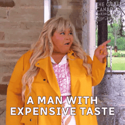 Woman In Yellow Coat Pointing At Man With Expensive Taste GIF