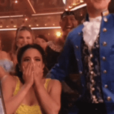 Woman In Yellow Dress Covering Mouth GIF