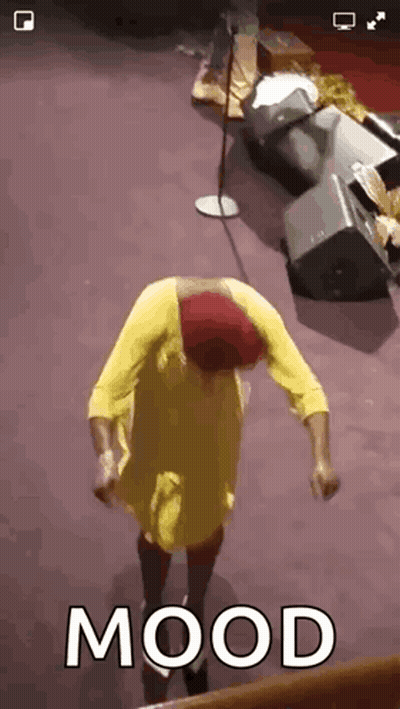 Woman In Yellow Dress Dancing At Microphone With Mood GIF