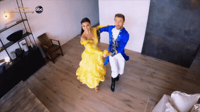 Woman In Yellow Dress Dancing With Man In Blue Costume On ABC GIF
