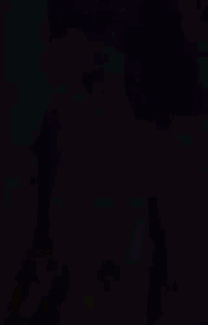Woman In Yellow Dress In Front Of Purple Background GIF