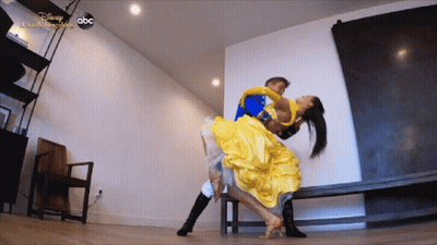 Woman In Yellow Dress Lifted By Man In Blue Costume Disney Dancing GIF