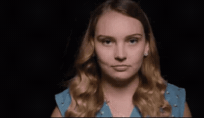 Woman In Yellow Dress Looking In Mirror Saying Me GIF