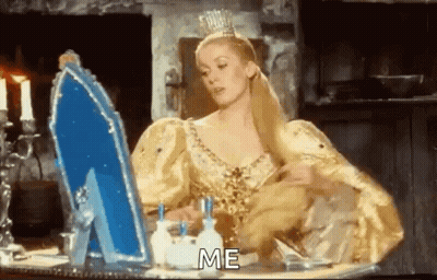 Woman In Yellow Dress Looking In Mirror Saying Me GIF