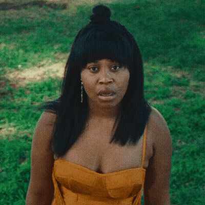 Woman In Yellow Dress Making Funny Face GIF