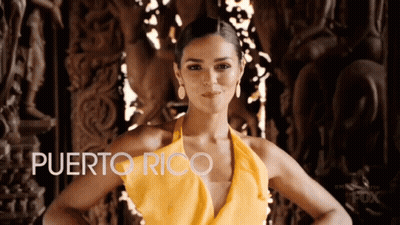 Woman In Yellow Dress Next To Puerto Rico Sign GIF