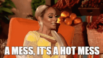 Woman In Yellow Dress On Orange Chair Saying Hot Mess GIF