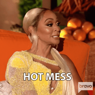 Woman In Yellow Dress On Orange Couch Saying Hot Mess GIF