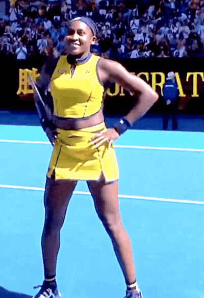 Woman In Yellow Dress On Tennis Court With Sr-At Sign GIF