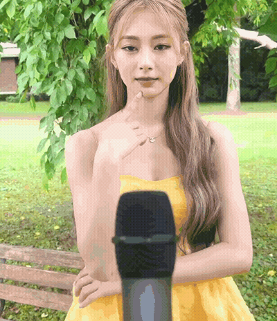 Woman In Yellow Dress Pointing At Microphone GIF