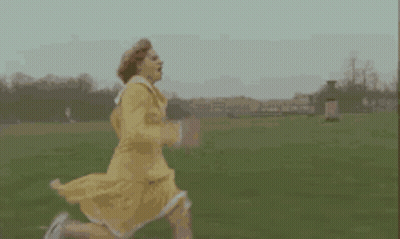 Woman In Yellow Dress Running In Field GIF