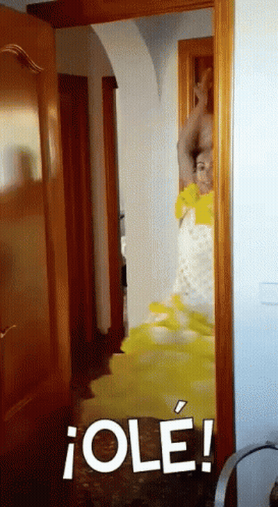Woman In Yellow Dress Standing In Doorway GIF