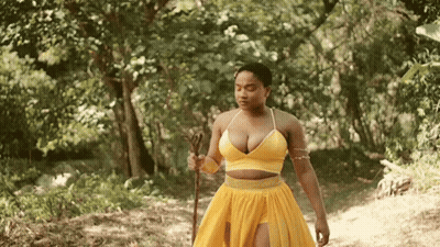 Woman In Yellow Dress With Cane In Forest GIF